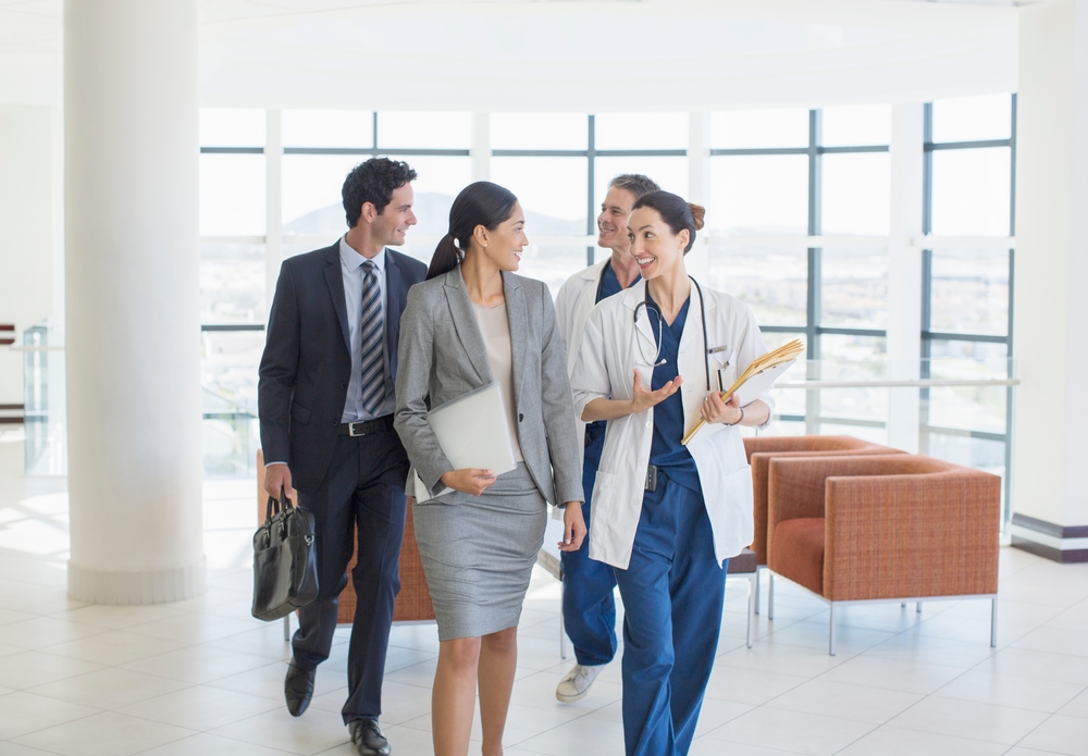 Doctors And Business People talking in a hospital lobby Doctors And Business People talking in a hospital lobby